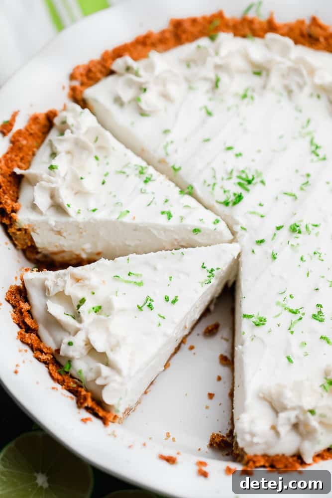 cut slices of key lime pie in a white pie plate