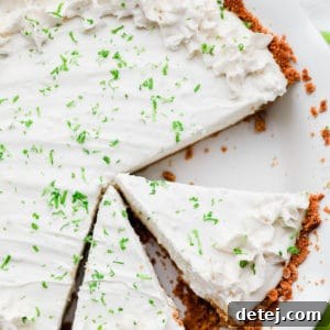 cut slices of key lime pie in a white pie plate