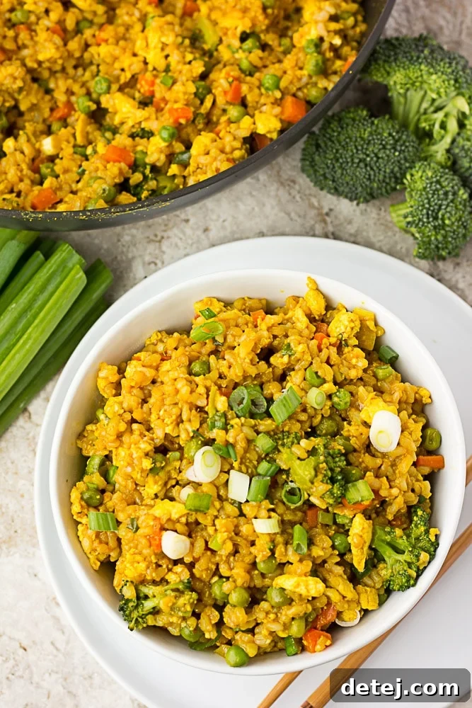 Golden Tofu Scramble Fried Rice 2 Looking down at a bowl of golden vegan fried rice, showcasing its vibrant colors and textures.