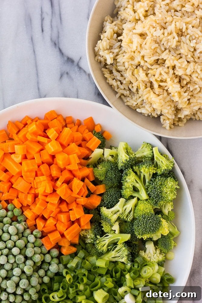 Golden Tofu Scramble Fried Rice 4 A vibrant bowl of Golden Fried Rice – a delicious vegan fried rice featuring scrambled tofu and an abundance of fresh, colorful vegetables.
