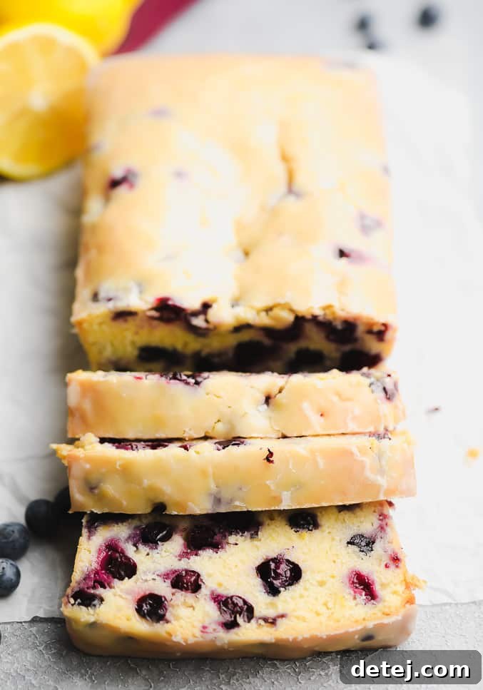 3 slices of blueberry bread neatly cut from the loaf, displaying its even crumb and berry distribution