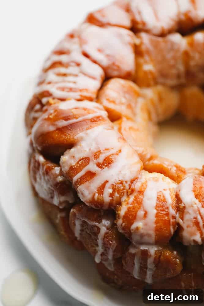 Close-up shot of a baked and glazed circle of golden brown monkey bread, showing its inviting texture.