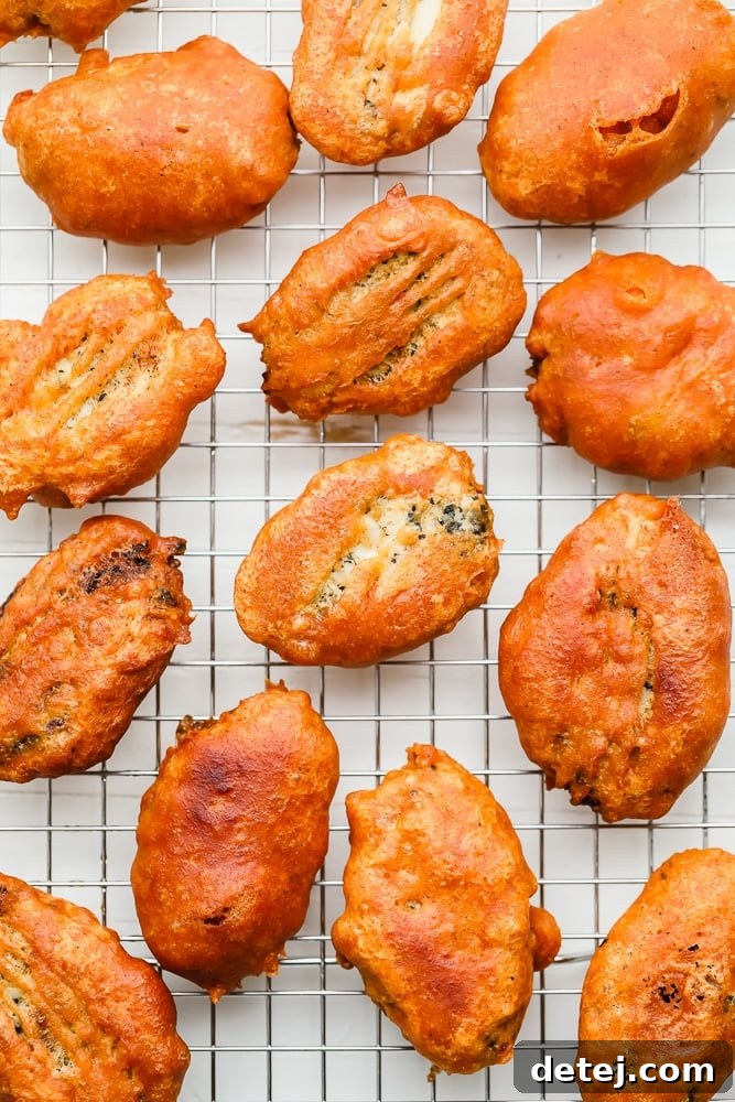 pieces of golden brown fried vegan fish on a wire rack