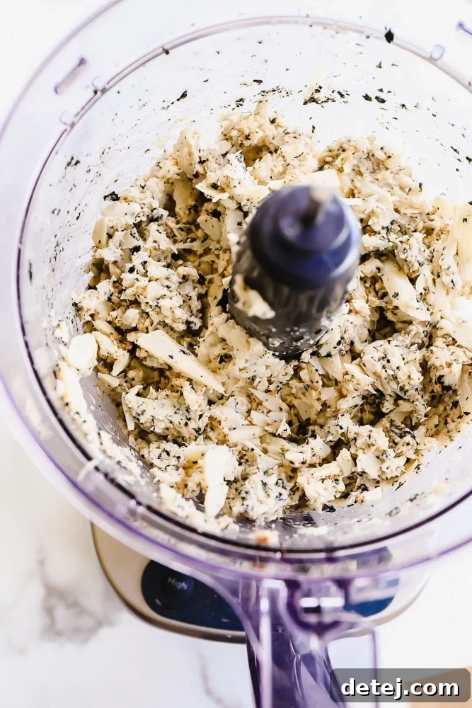 white mixture with green flecks in a food processor