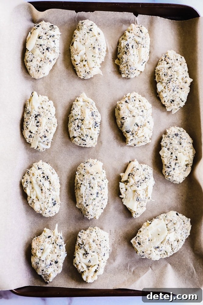 white vegan fish sticks on a parchment lined baking sheet