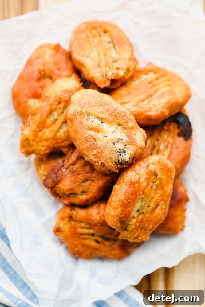 piles of golden brown vegan fried fish on a piece of white parchment paper