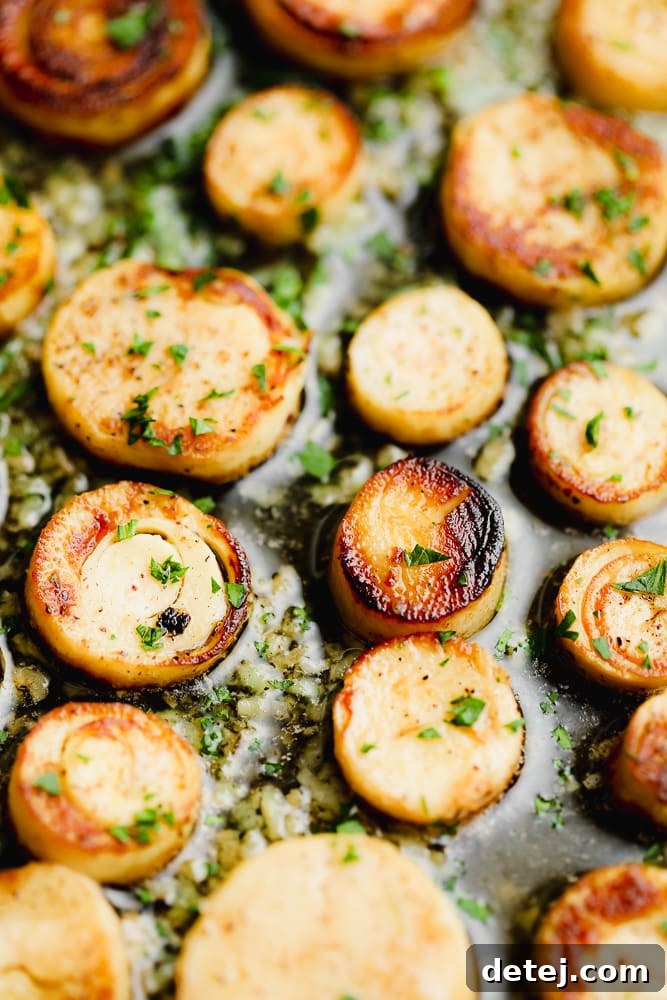 Close-up of perfectly seared golden-brown vegan scallops nestled on a bed of angel hair pasta, garnished with fresh parsley.