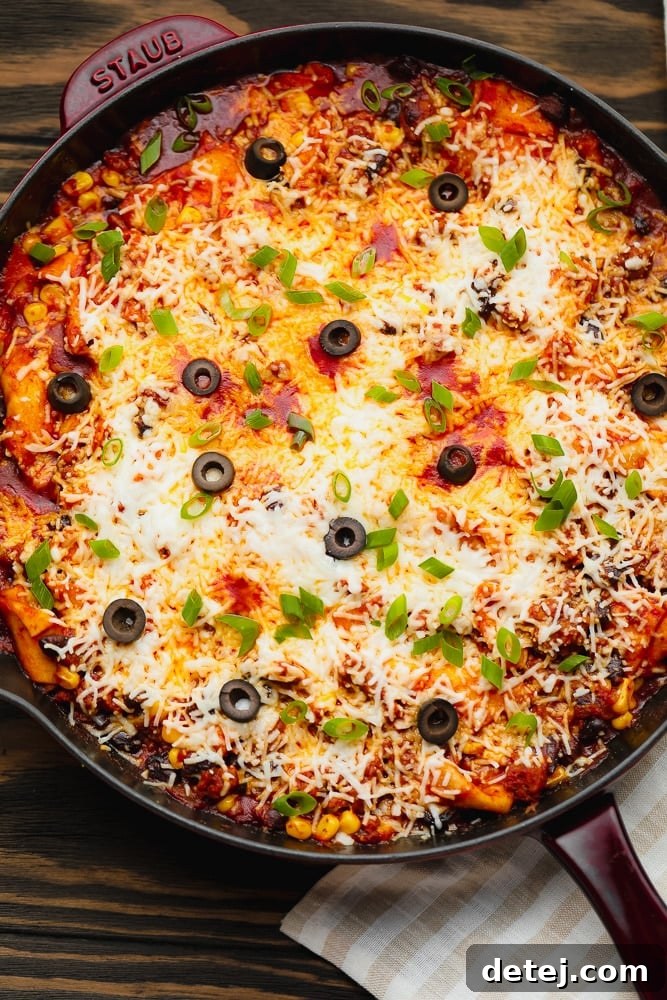 A close up of a pan filled with Mexican casserole, highlighting the textures and colors of the ingredients.