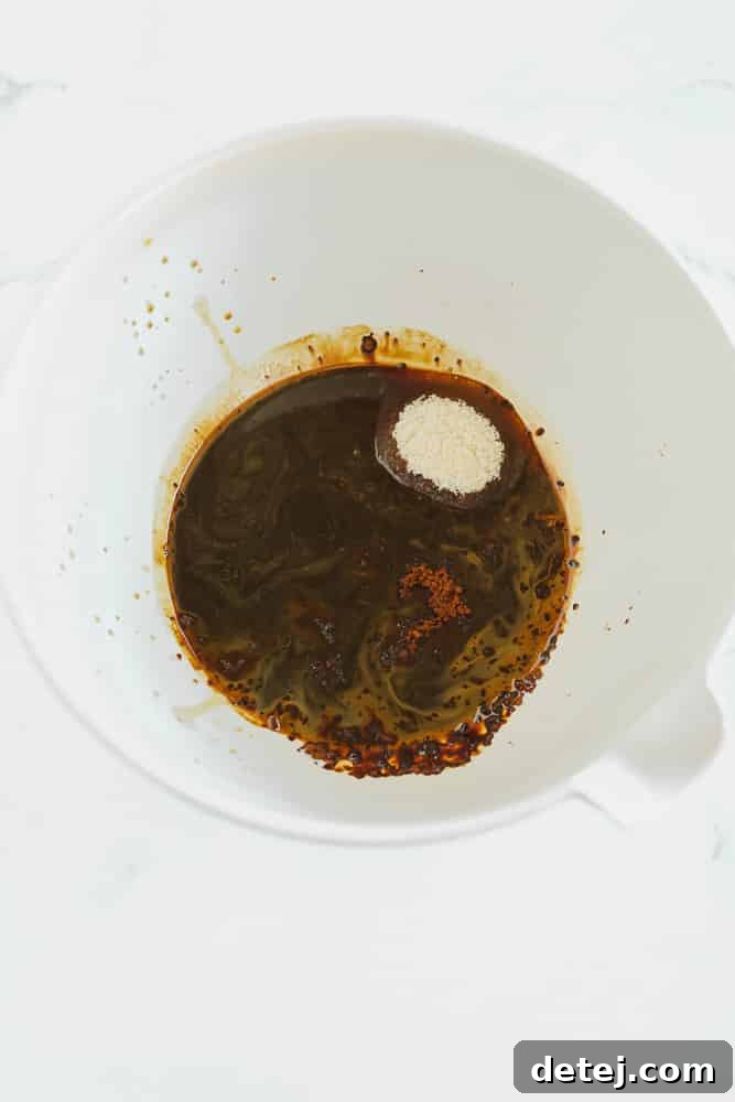 Cloud Coffee 4 Dark brown liquid with white sugar in a large white bowl, before whipping