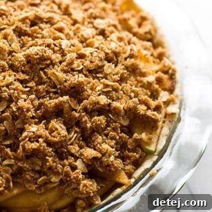 Gluten Free Vegan Apple Crumble Pie: Made with an almond flour crust, minimal oil, and full of sticky sweet apples with a perfect crumble topping.