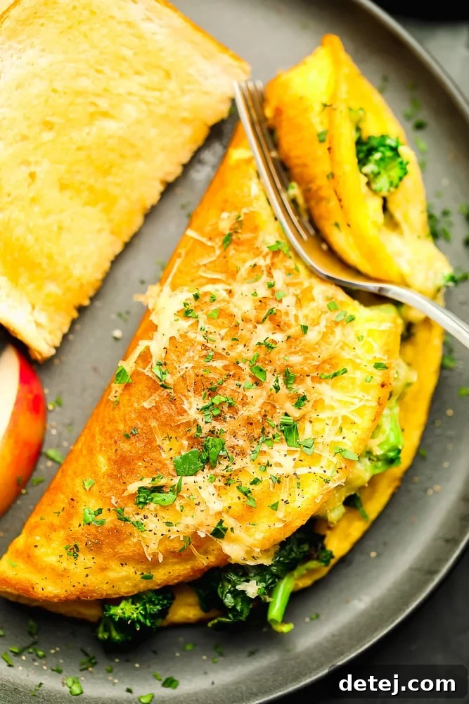 A fork cutting into a fluffy vegan omelette, revealing its flavorful vegetable and cheese filling.