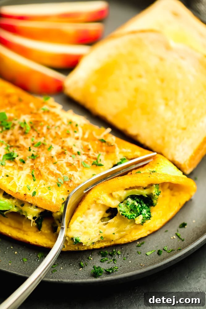 A perfectly cooked vegan omelette on a grey plate, with a fork ready to enjoy, showcasing its delightful texture and presentation.