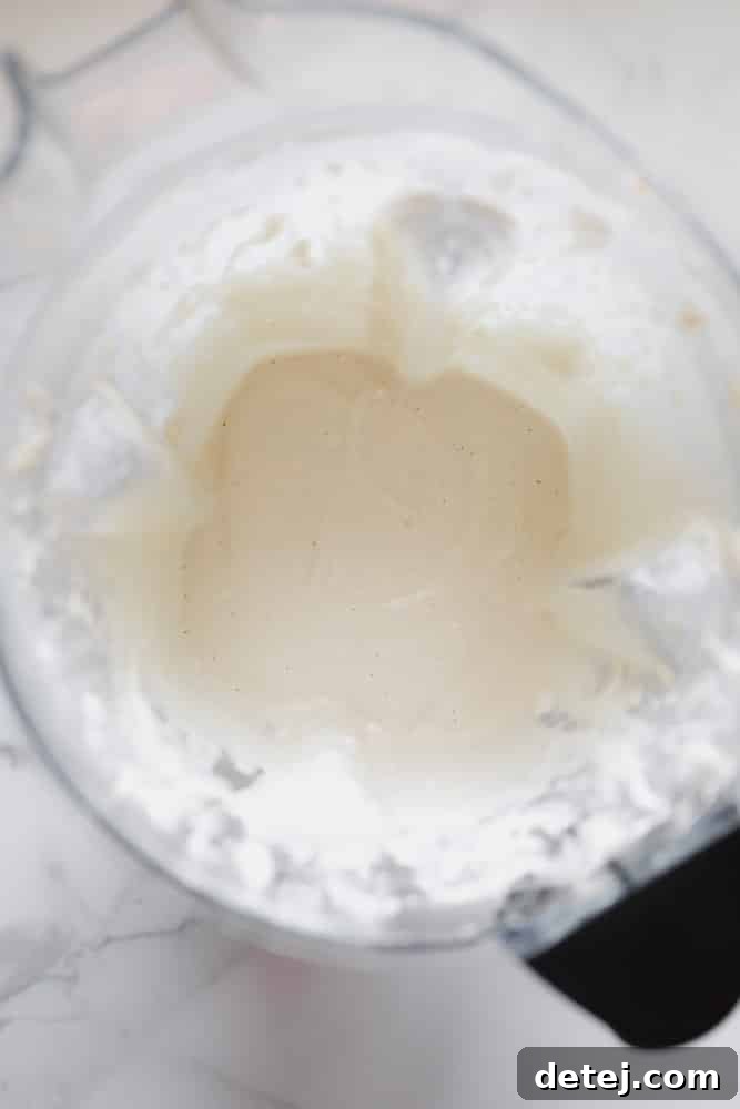 smooth white cashew cream in a blender, after agar agar has been added