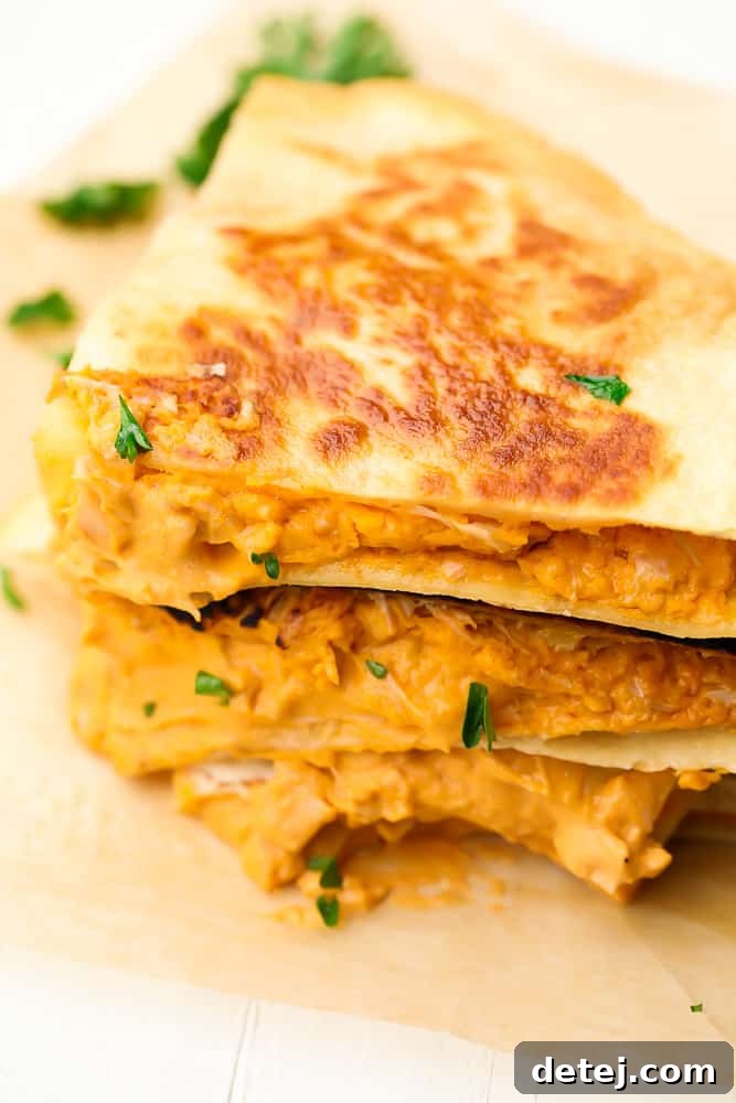 Crispy golden Buffalo Jackfruit Quesadillas on a white background, ready to be served.