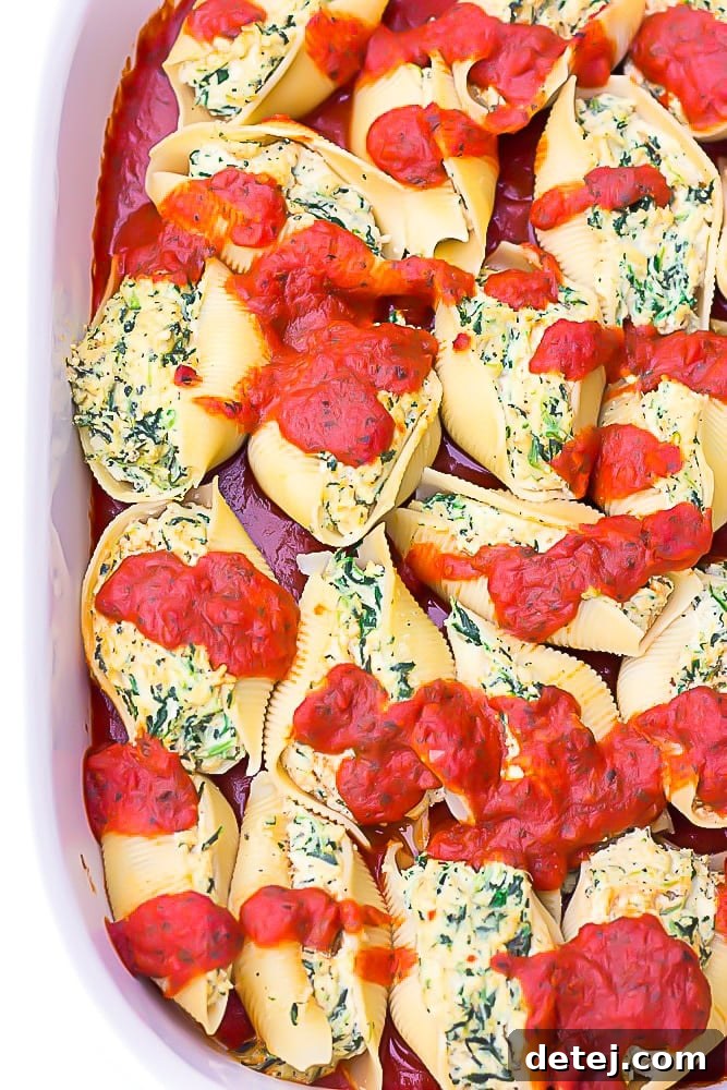 large casserole dish filled with vegan stuffed shells covered in sauce