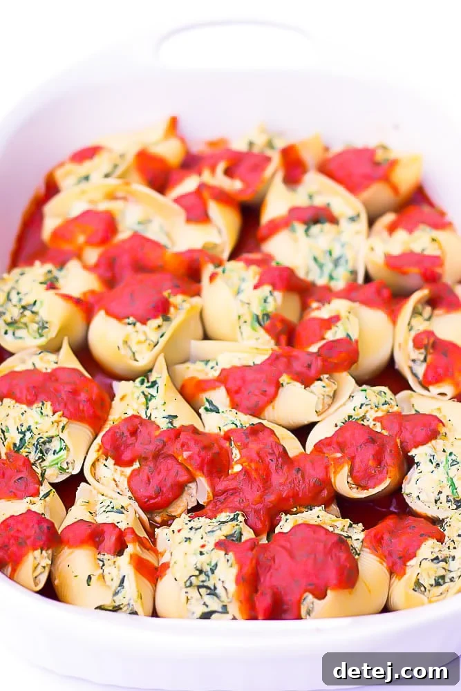 side shot of a casserole dish full of shells with marinara