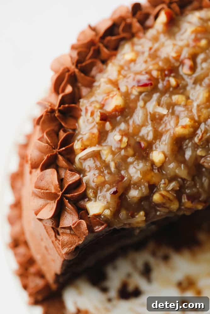 Close up on a beautifully frosted vegan chocolate cake, topped with a rich pecan caramel sauce.
