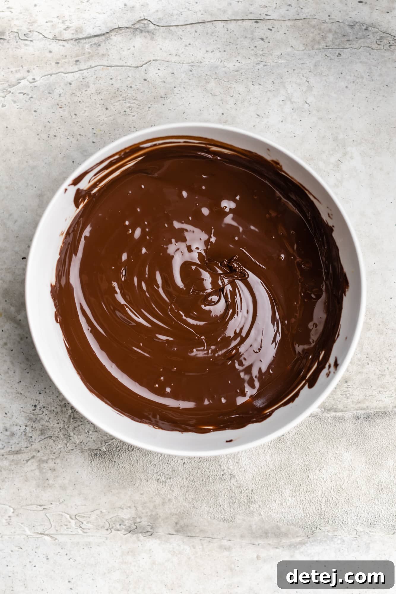 Velvet Vegan Chocolate Indulgence 5 melted chocolate in a large white bowl.