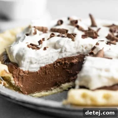 Velvet Vegan Chocolate Indulgence 10 side view of vegan chocolate pie with a slice removed.