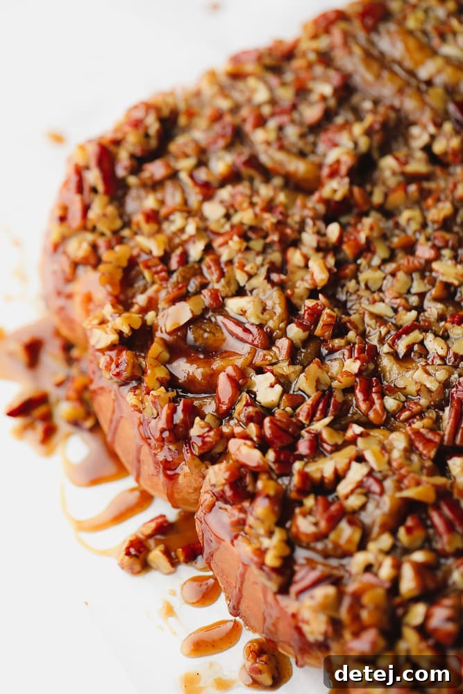 A baking dish filled with unbaked sticky buns, showcasing the rich pecan and caramel topping, ready to be transformed into a golden masterpiece.