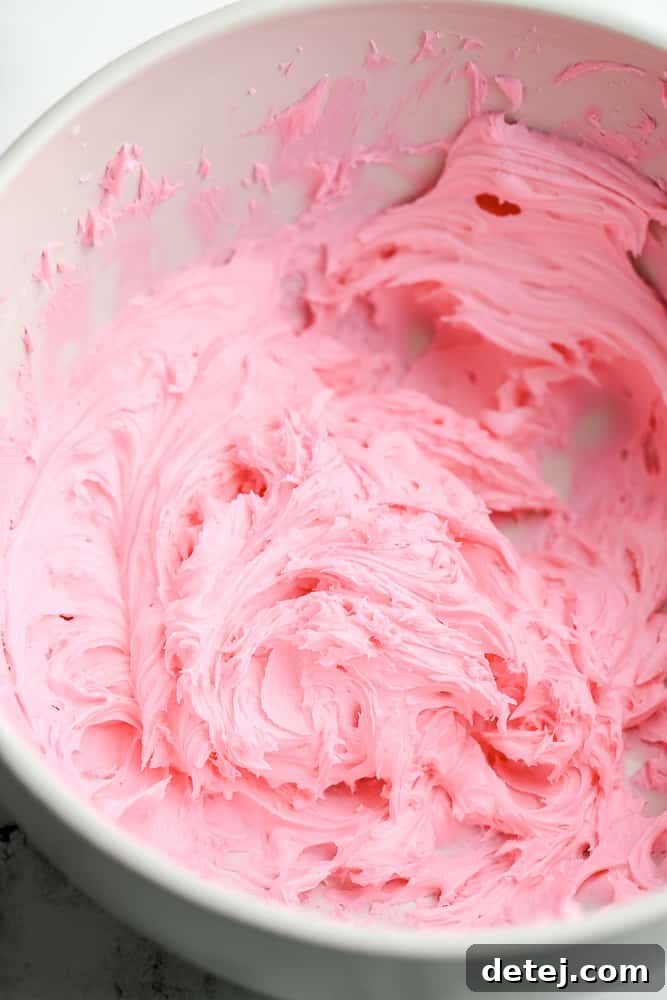 A bowl filled with freshly made, vibrant pink vegan frosting, ready for decorating.