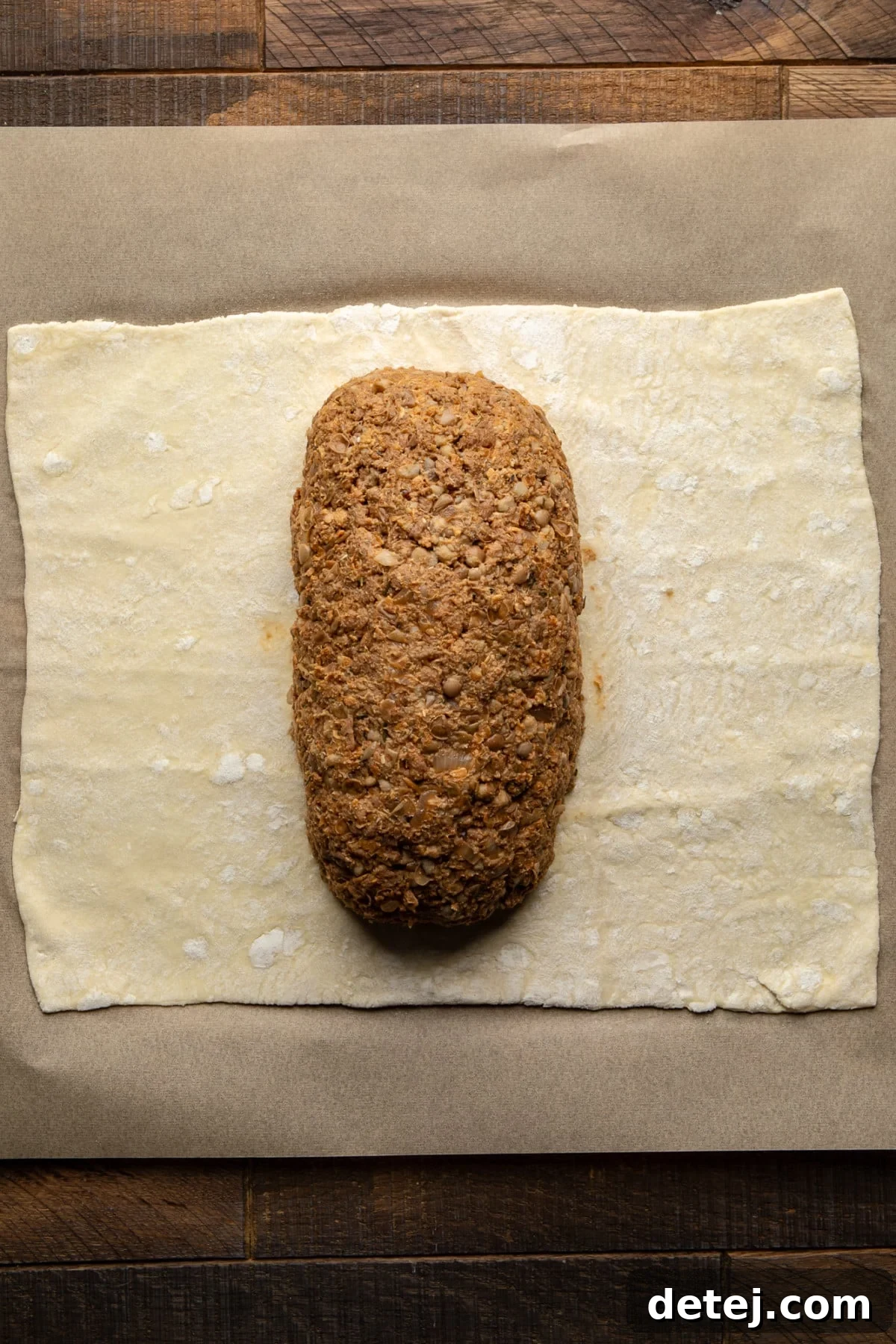 The savory vegan filling perfectly centered on a sheet of puff pastry, ready for assembly.
