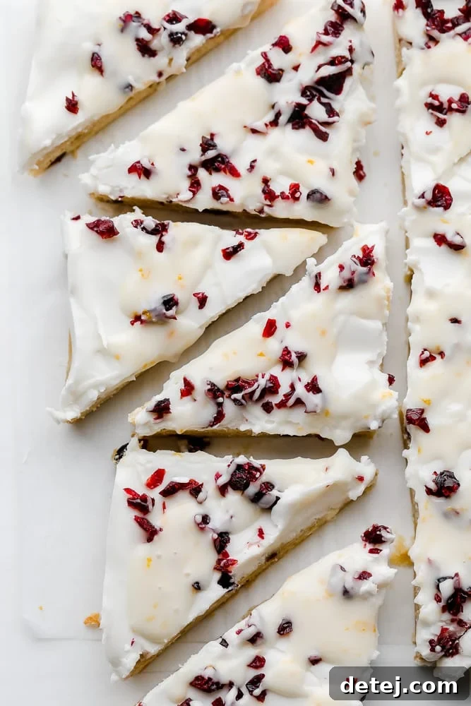 white chocolate and cranberry cookie bars cut into triangles.