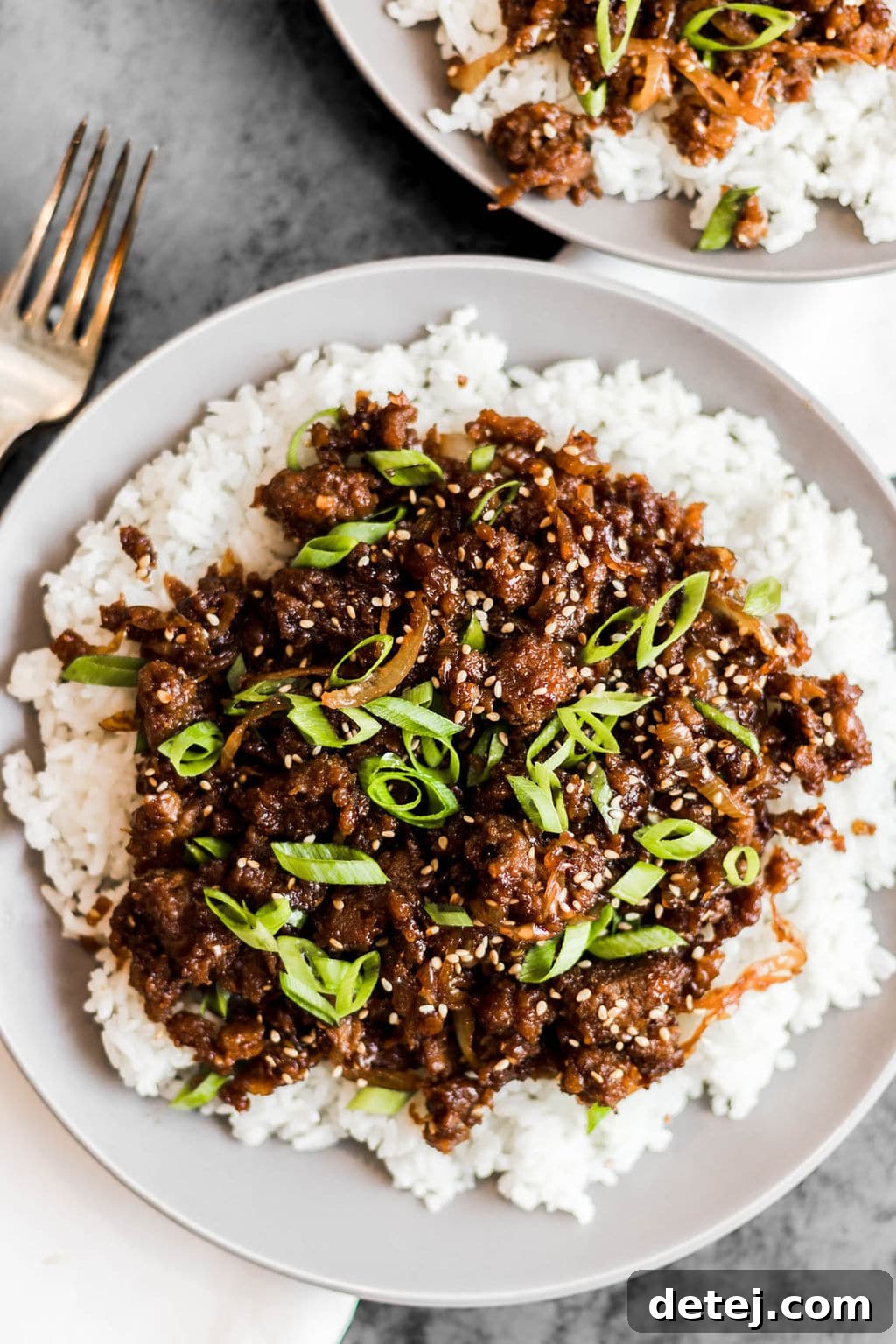 white rice and cooked ground vegan beef on a white plate.
