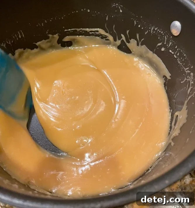 Smooth, glossy vegan caramel resting in a pot after cooking, ready to be poured.