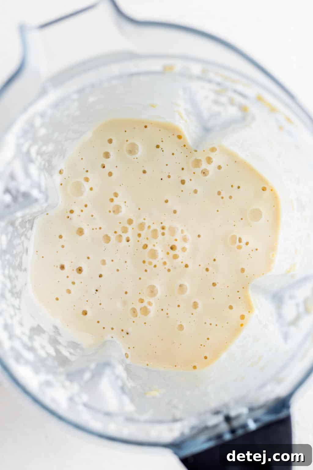 creamy white liquid in a blender.