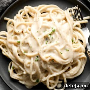 dark grey plate with pasta and creamy sauce