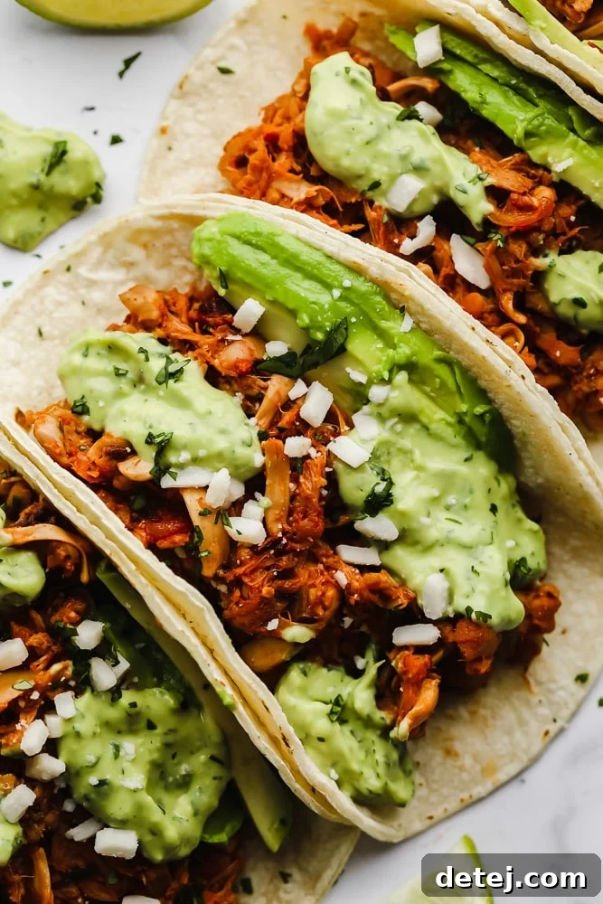 Pulled Jackfruit Tacos 3 close up on jackfruit tacos topped with a green avocado sauce.