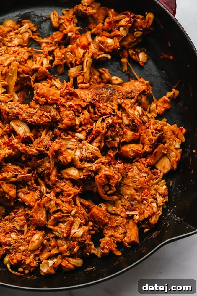 Pulled Jackfruit Tacos 5 cooked, seasoned, and shredded jackfruit in a black skillet.