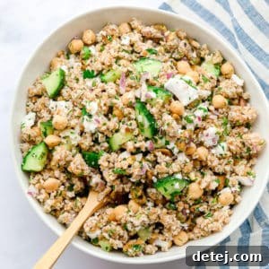 white bowl with grain salad, chickpeas and veggies
