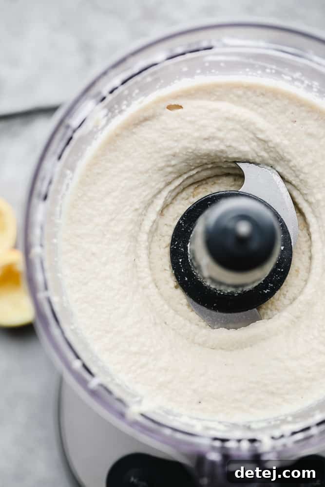 Close-up of the smooth, creamy vegan mascarpone mixture in a food processor, after blending to perfection.
