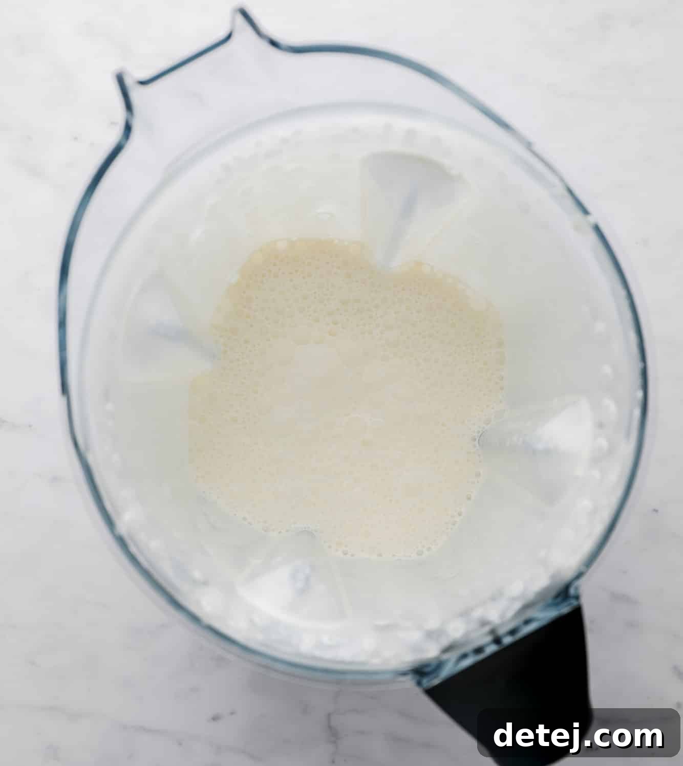 bubbly coconut oil and soy milk in a large blender.