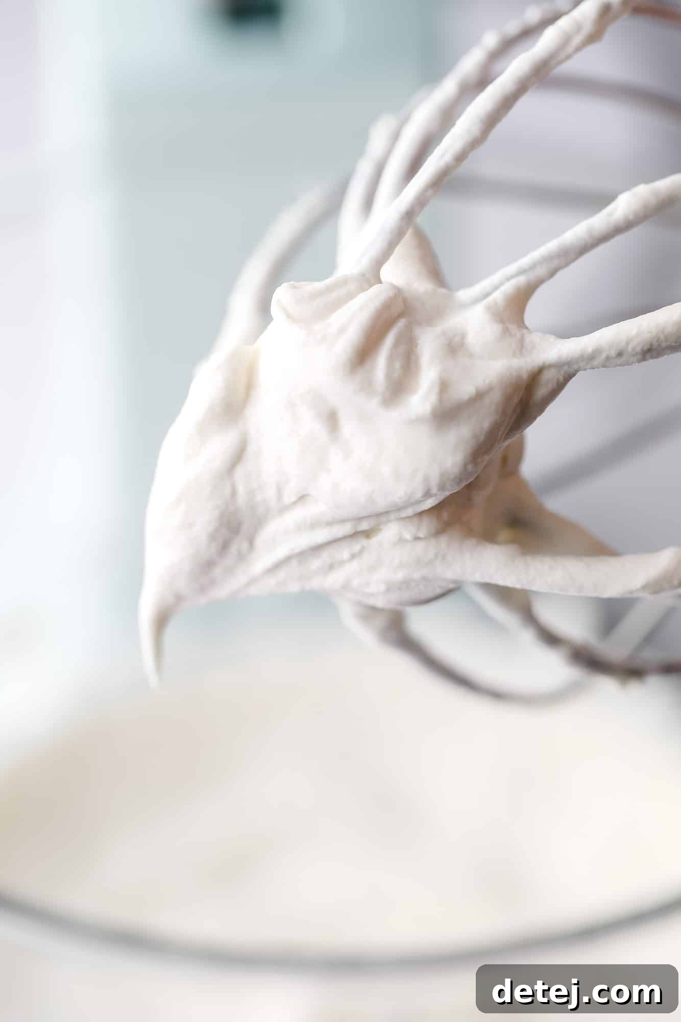 close up on vegan whipped cream on a whisk.