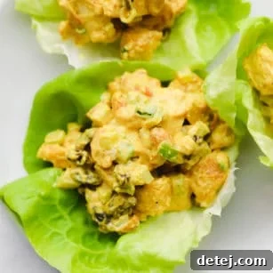 Golden Curried Tofu Salad 8 close up on a creamy curry tofu salad in a lettuce cup.