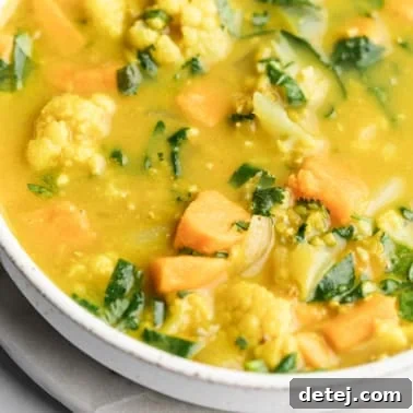close up on coconut curry lentil soup in a large white bowl.
