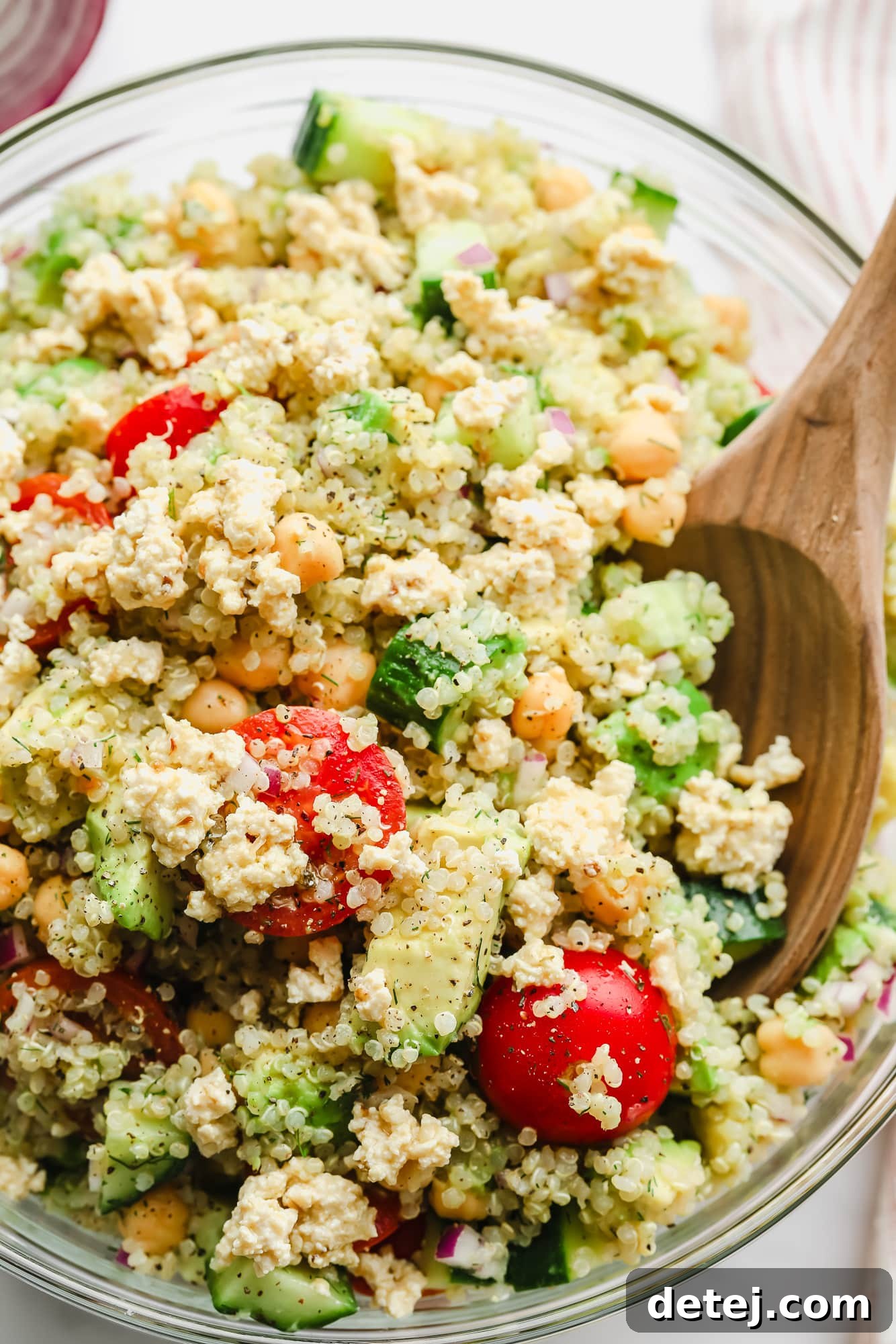 close up on quinoa salad with chickpeas in a large glass bowl.