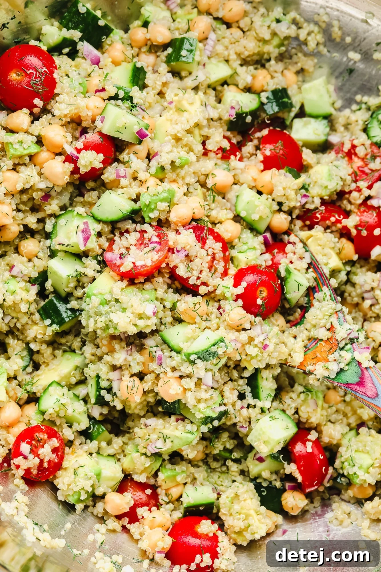 quinoa salad with chickpeas and vegetables in a large bowl.