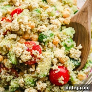 close up on quinoa salad with chickpeas in a large glass bowl.
