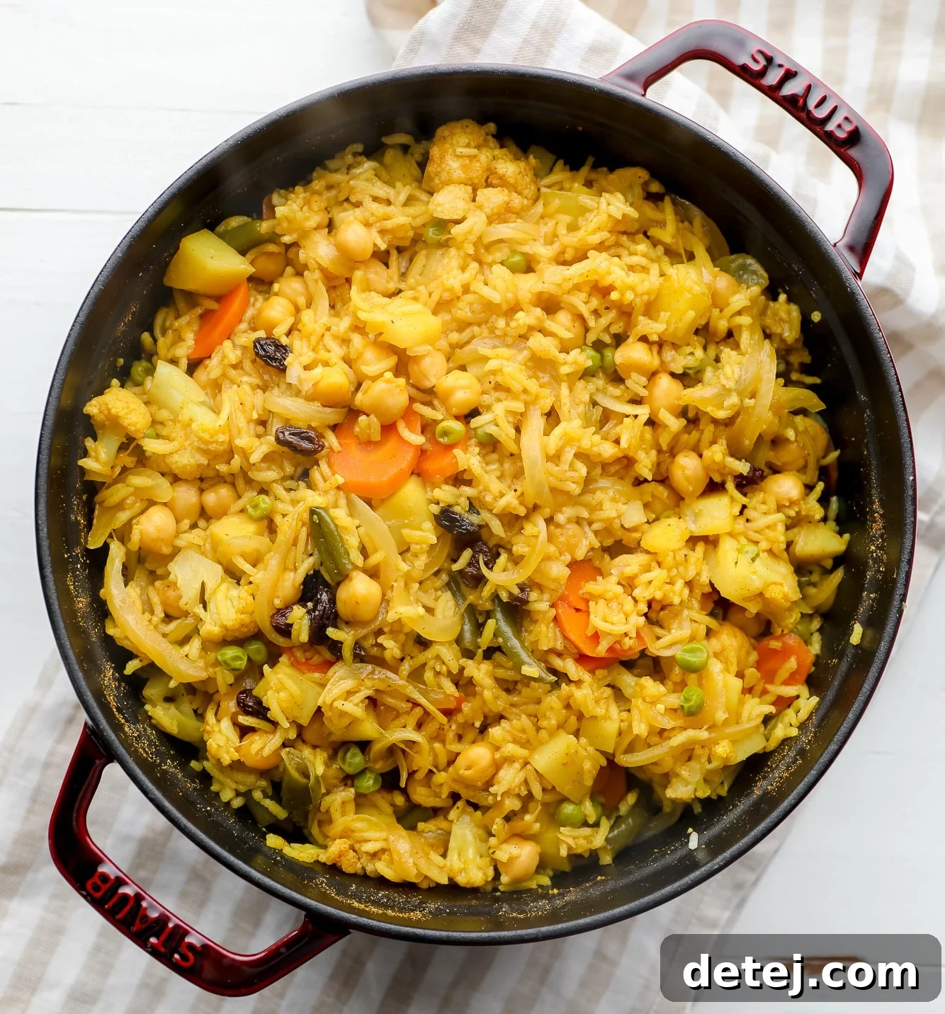 The fully cooked vegan biryani in a large black pot, garnished and ready to serve.
