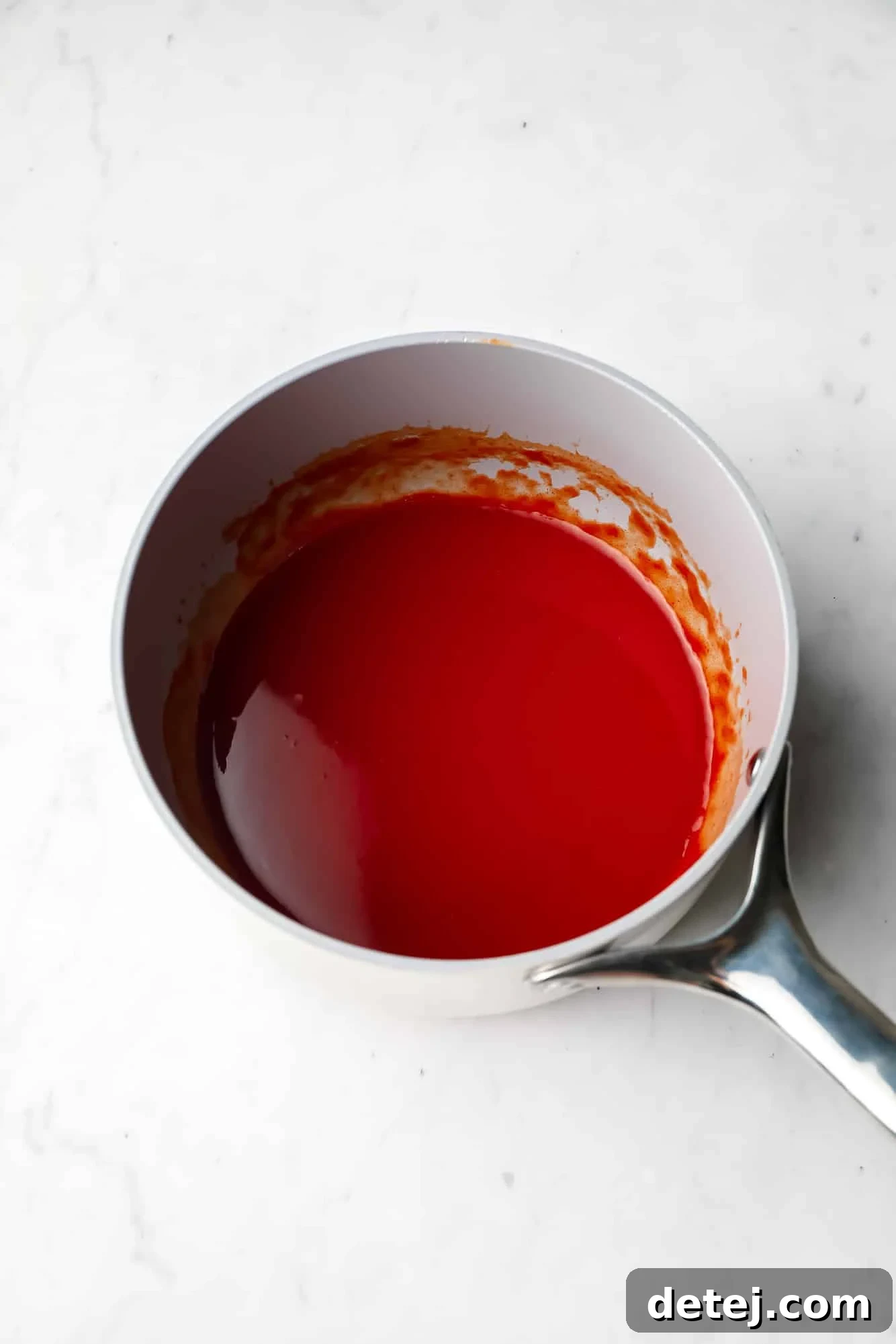 buffalo sauce in a grey saucepan.