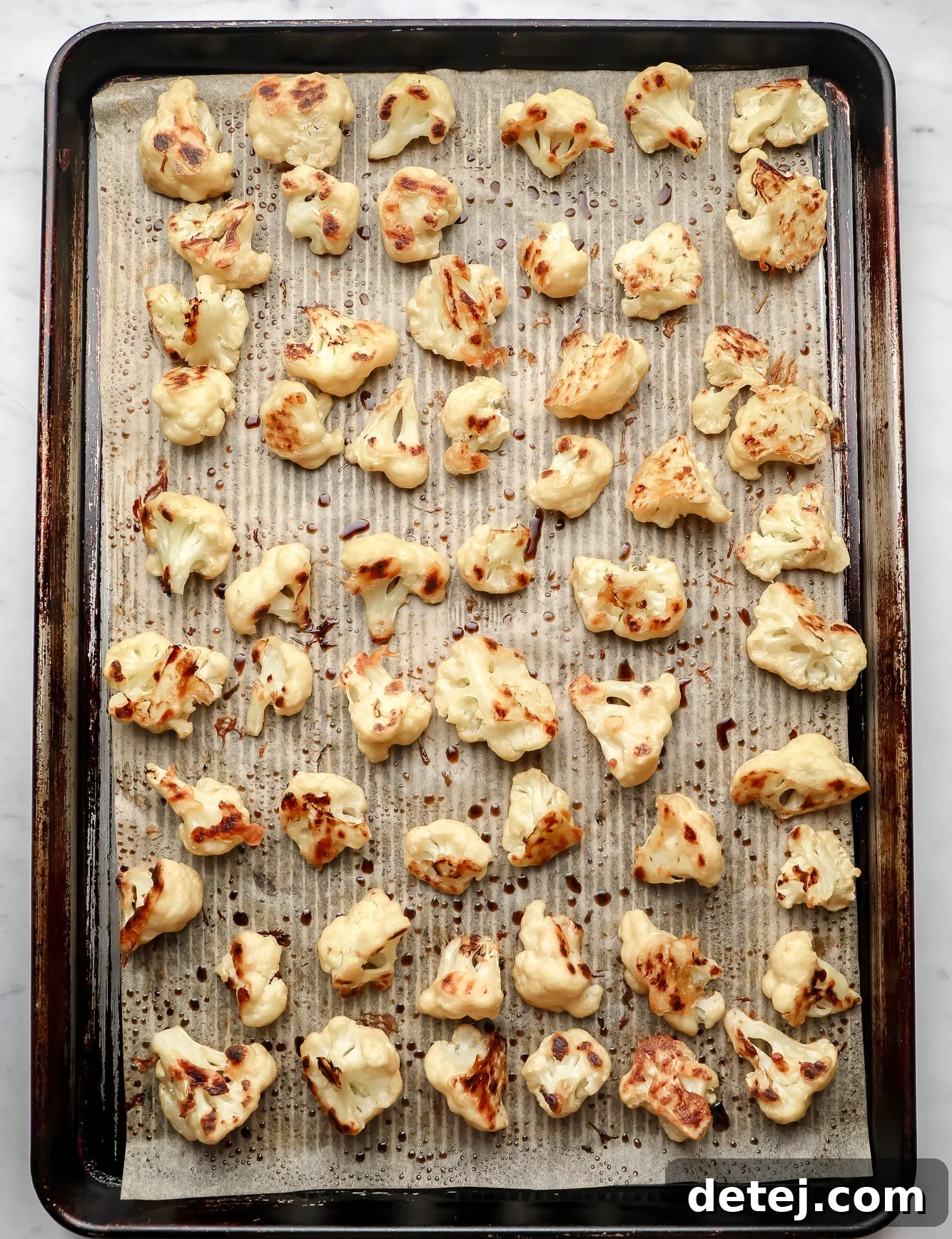 baked cauliflower in rows on a baking sheet.