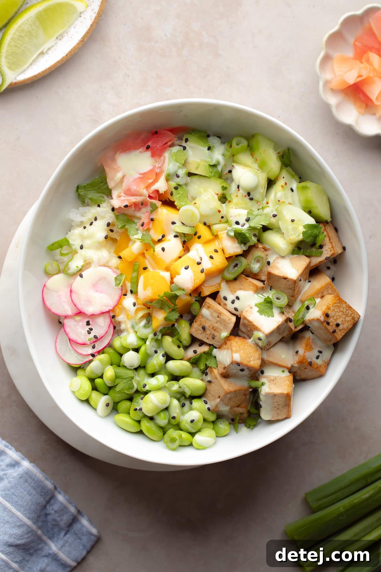 vegan poke bowl with rice, tofu, mango, avocado and edamame