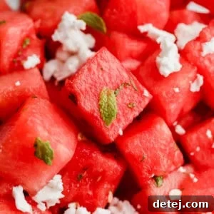 A tantalizing square image of a bowl of watermelon salad with fresh mint and crumbled feta, inviting you to taste summer.