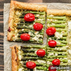Square image of puff pastry with asparagus, feta and tomatoes