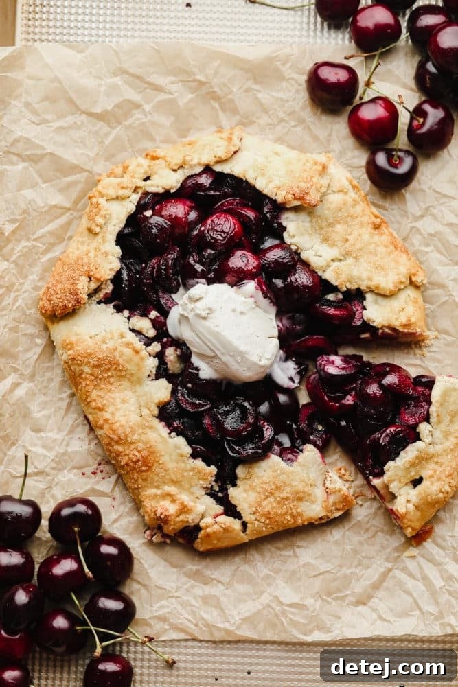Rustic Cherry Tart 2 cherry galette cut into on parchment paper