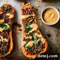 Creamy lentil stuffed butternut squash, an impressive and hearty main course for any winter or holiday dinner.